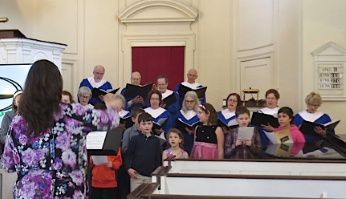 Claudia conducting the choir at First Parish Framingham